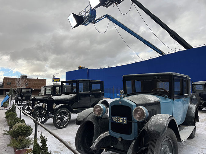 1920s era cars used in the filming of “1923” line the front of the train depot in Butte, Montana. The blue backdrop and lights behind them block the cars from public view on Front Street. 1920s era cars used in the filming of “1923” line the front of the train depot in Butte, Montana. The blue backdrop and lights behind them block the cars from public view on Front Street.