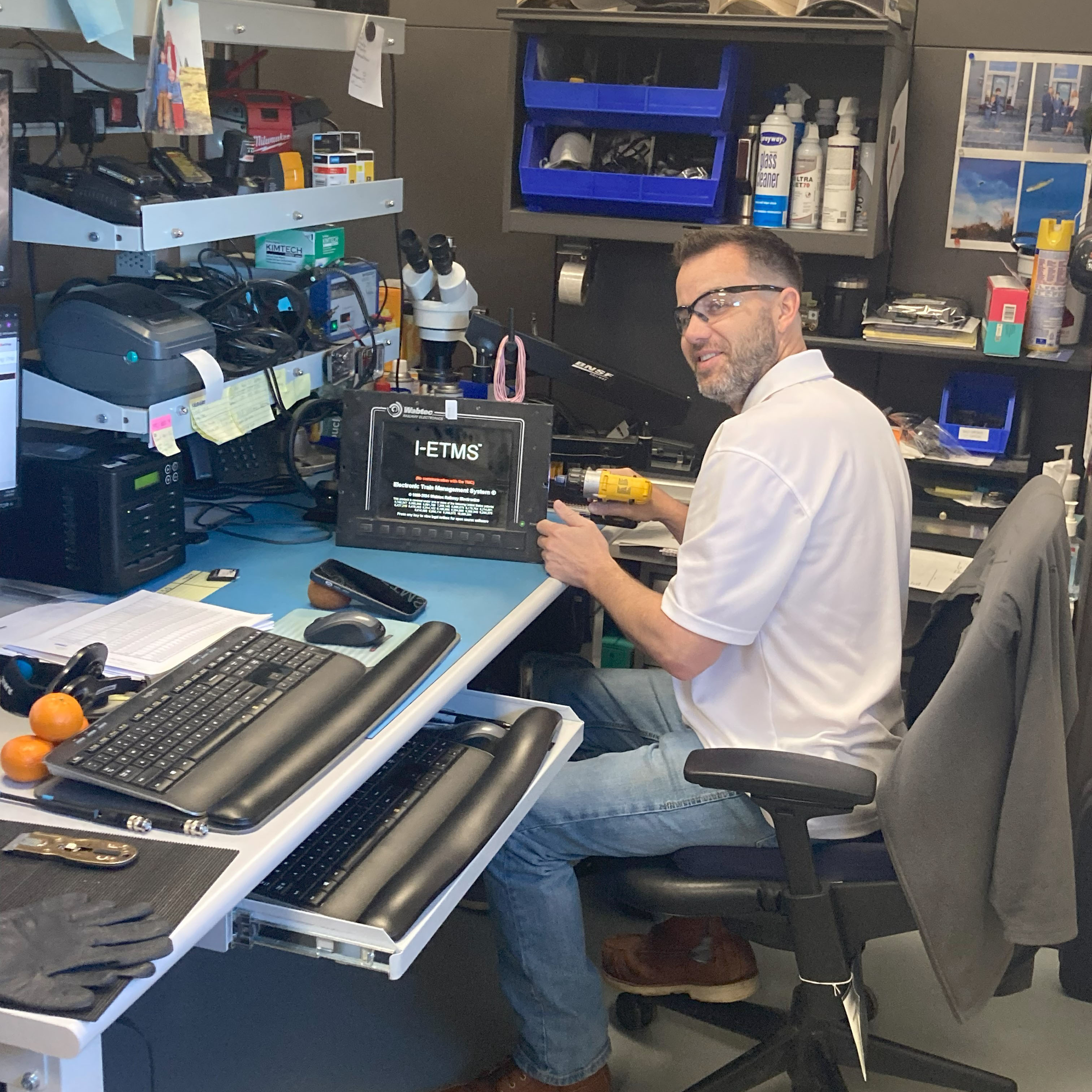 Curtis Faulconer, electronic technician II, repairs an I-ETMS console.  Curtis Faulconer, electronic technician II, repairs an I-ETMS console.