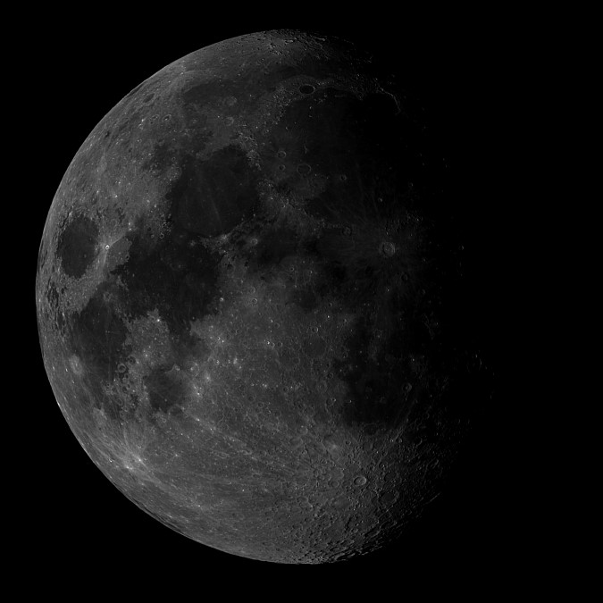 The dark areas in this photo are lava flows that occurred when the moon was struck by asteroids and comets after it was fully formed, but not yet fully solid.  The dark areas in this photo are lava flows that occurred when the moon was struck by asteroids and comets after it was fully formed, but not yet fully solid.