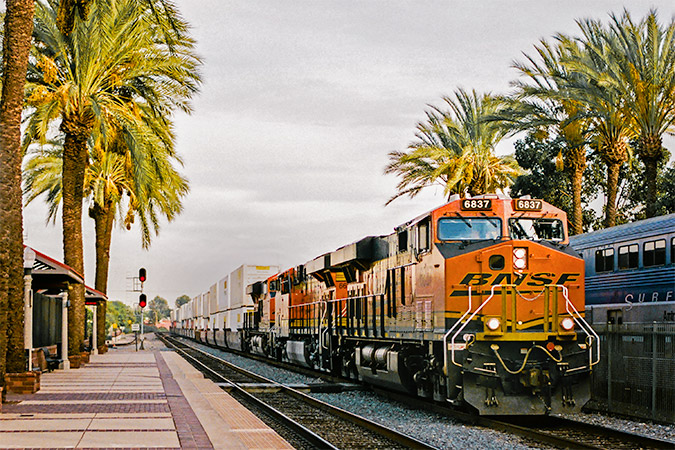 A train loaded with consumer goods heads out in California.  A train loaded with consumer goods heads out in California.