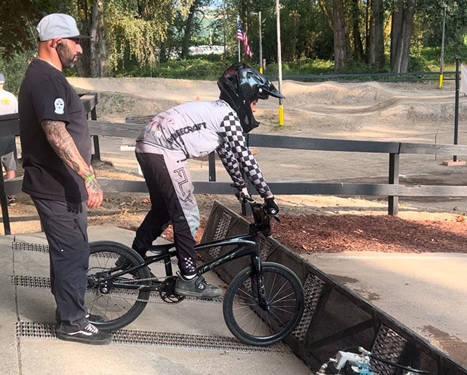 Azus checks a rider’s form.  Azus checks a rider’s form.