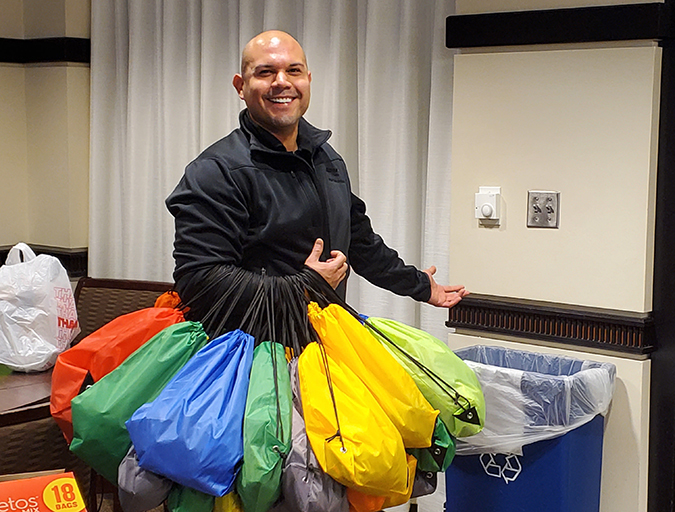 Fernando Garcia, a member of the NOC Diversity Council, gathers bags employees collected for Homeless Outreach in downtown Fort Worth. Fernando Garcia, a member of the NOC Diversity Council, gathers bags employees collected for Homeless Outreach in downtown Fort Worth.