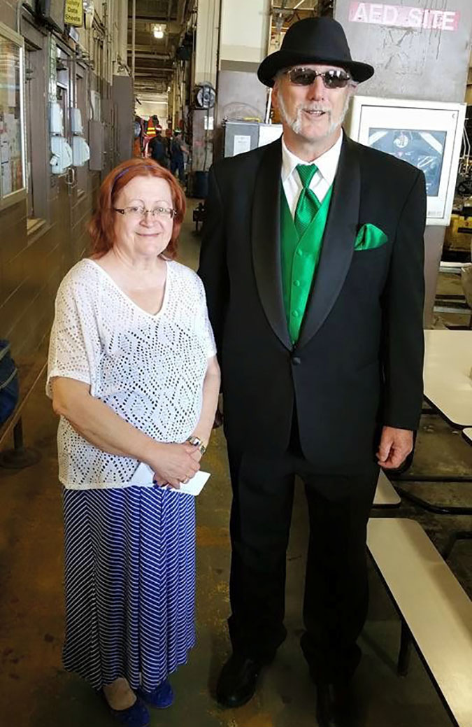 Mark and his wife at his retirement party. “It was common for most men to wear a suit on their final day,” he said of his BN green accessories.   Mark and his wife at his retirement party. “It was common for most men to wear a suit on their final day,” he said of his BN green accessories.