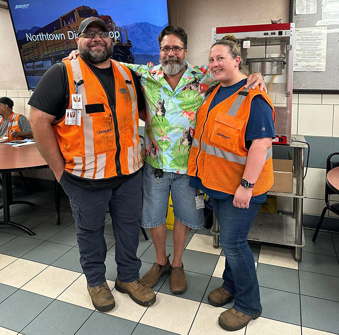 Kimberly and Matt Dunn (in orange vest) with a coworker.  Kimberly and Matt Dunn (in orange vest) with a coworker.