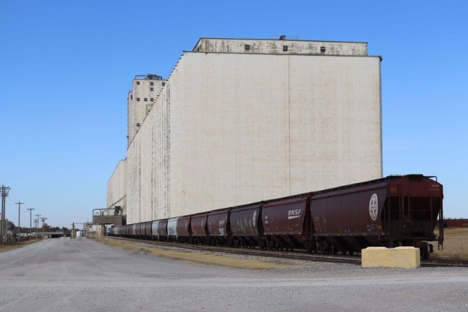 BNSF Train cars being filled by grain from one of the Enid Grain Elevators BNSF Train cars being filled by grain from one of the Enid Grain Elevators
