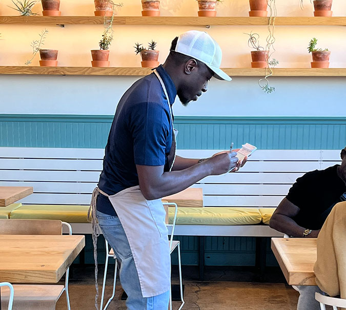Richard Olaniyi takes an order during the BNSF volunteer day at Taste.  Richard Olaniyi takes an order during the BNSF volunteer day at Taste.