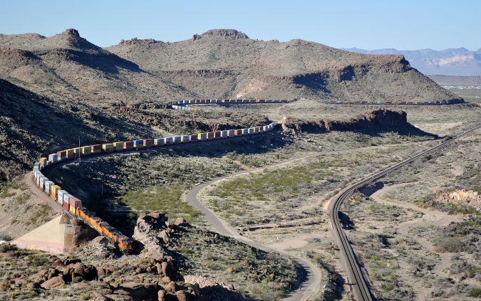 From Julien’s collection, a BNSF train parallels a portion of Route 66 near Kingman, Arizona.  From Julien’s collection, a BNSF train parallels a portion of Route 66 near Kingman, Arizona.