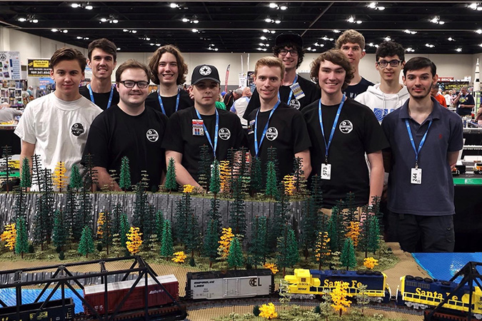 The EmpireLUG team collectively built the layout for the Brickworld Chicago convention. Front row (left to right): Lee Roberts, Anthony Davis, Ben Fillinger, Matt Welch, Gage Hunt, Andrès Cazenave-Tapie Back row (left to right): Josh Bretz, Max Finnemore, Gavin Smith, Quinlan Barwick, Nolan T. The EmpireLUG team collectively built the layout for the Brickworld Chicago convention. Front row (left to right): Lee Roberts, Anthony Davis, Ben Fillinger, Matt Welch, Gage Hunt, Andrès Cazenave-Tapie Back row (left to right): Josh Bretz, Max Finnemore, Gavin Smith, Quinlan Barwick, Nolan T.