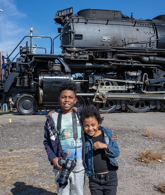 Daecian and his sister Kate standing in front of a steam locomotive.  Daecian and his sister Kate standing in front of a steam locomotive.