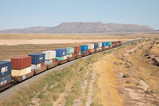 A BNSF intermodal train with stacks of containers  A BNSF intermodal train with stacks of containers