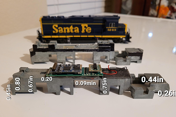 Thomas places sound chips and control cards in the belly of his locomotives. Thomas places sound chips and control cards in the belly of his locomotives.