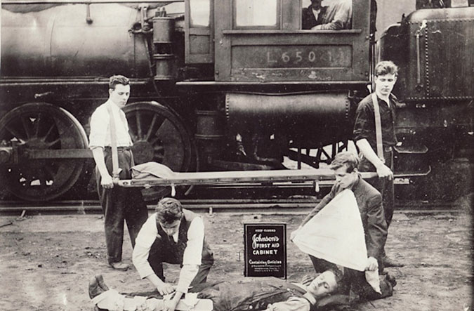 A rail crew in 1916 demonstrates the use of a first-aid kit on an uninjured volunteer. Operating rules have changed since 1916. A rail crew in 1916 demonstrates the use of a first-aid kit on an uninjured volunteer. Operating rules have changed since 1916.