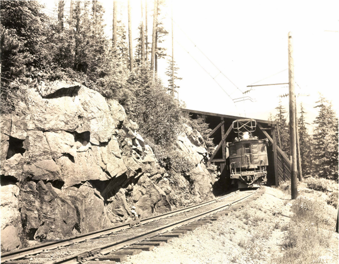 An electric locomotive emerging from a snow shed in the 1900s. An electric locomotive emerging from a snow shed in the 1900s.