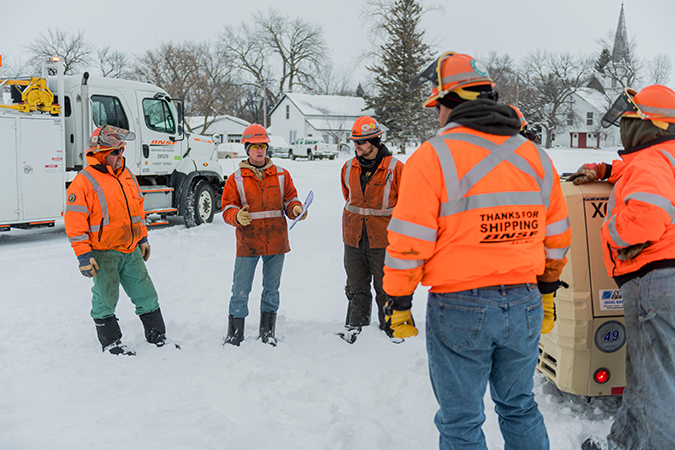 Crew members start their workday with a safety briefing.  Crew members start their workday with a safety briefing.