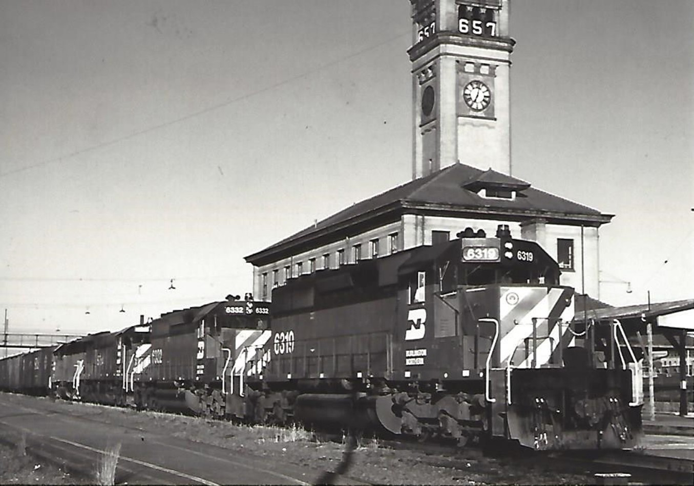 A Burlington Northern train at the Great Northern depot and clock tower, circa 1972. The “657” on the clock tower is a countdown clock, indicating 657 days until the start of the World’s Fair/Expo.  A Burlington Northern train at the Great Northern depot and clock tower, circa 1972. The “657” on the clock tower is a countdown clock, indicating 657 days until the start of the World’s Fair/Expo.