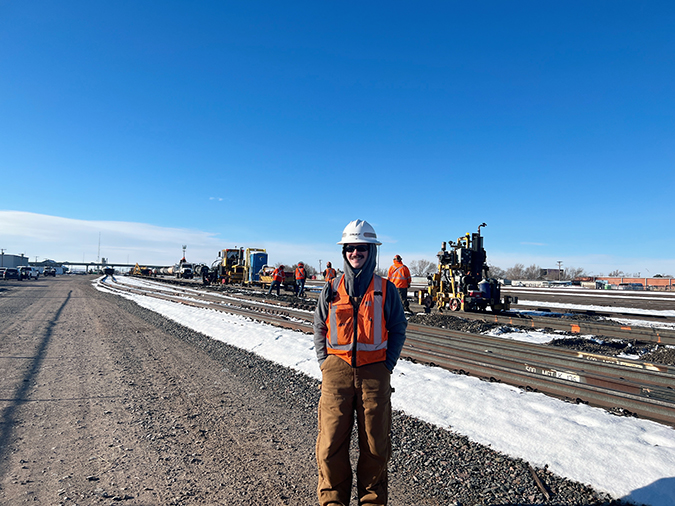 Assistant Roadmaster Brady Sewell, foreground, with orange-marked rail in the background indicating ties to pull.  Assistant Roadmaster Brady Sewell, foreground, with orange-marked rail in the background indicating ties to pull.