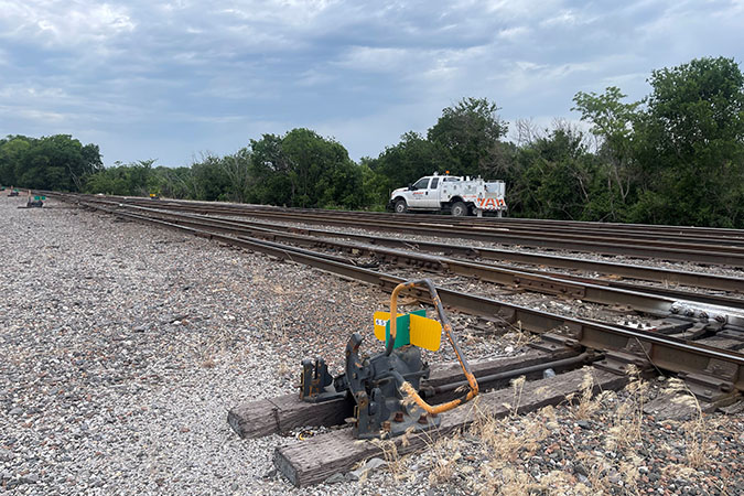 Switch with a hyrail vehicle in background Switch with a hyrail vehicle in background