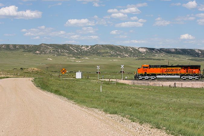 A BNSF train approaches a crossing in Wyoming. A BNSF train approaches a crossing in Wyoming.