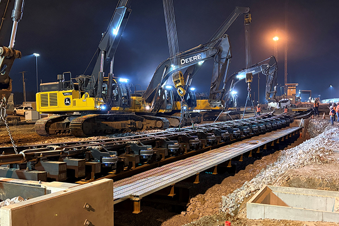 Work continued around the clock. During the night, crews set the Group 2 retarder in place on new bridge foundation. Work continued around the clock. During the night, crews set the Group 2 retarder in place on new bridge foundation.