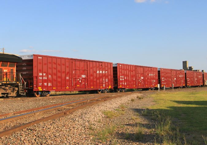 A BNSF train moves packaged sugar in boxcars.  A BNSF train moves packaged sugar in boxcars.
