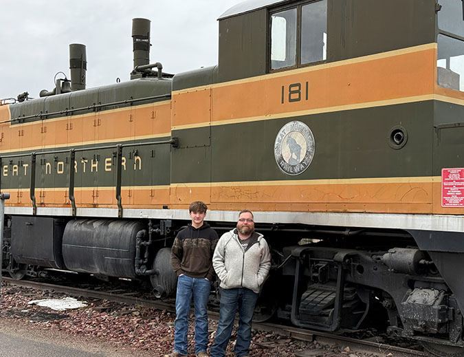 Xander and his dad in front of an old Great Northern switch engine at BNSF’s depot in Whitefish.   Xander and his dad in front of an old Great Northern switch engine at BNSF’s depot in Whitefish.